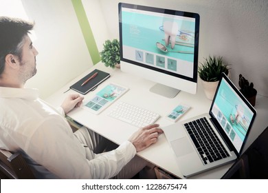 Man Working With Devices With Dental Clinic Website. All Screen Graphics Are Made Up.