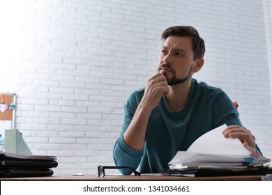 Man working with documents at table in office. Space for text - Shutterstock ID 1341034661