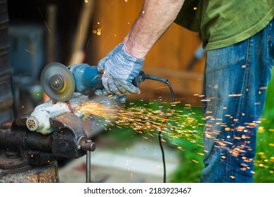 Man Working With Grinder Saw, Close Up View On Tool. Electric Saw And Hands Of Worker With Sparks. Worker Cutting Metal With Grinder.