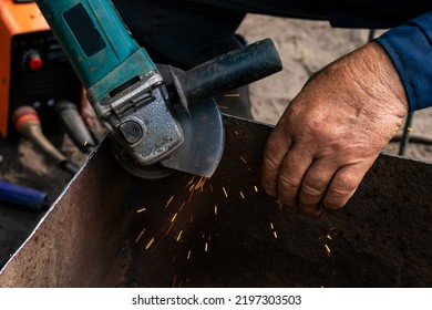 Man Working With Grinder Saw, Close Up View On Tool. Electric Saw And Hands Of Worker With Sparks. Worker Cutting Metal With Grinder,