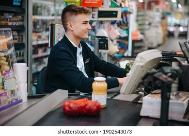 Man Working At Grocery Store Checkout. Young Worker On Holiday Job At Supermarket.