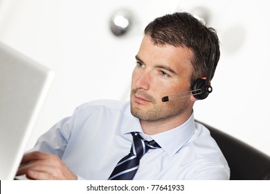 Man Working With Headset And Computer In Office