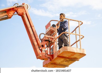 man working at heights with lifting platform.
