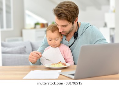 father taking care of baby