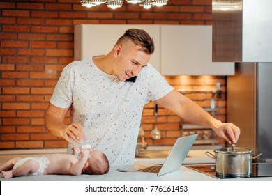 Man Working From Home, Talking On Phone, Cooking And Taking Care Of Baby