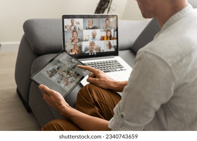man working from home use Smart working and video conference online meeting with team using laptop and tablet online in video call for new projects - Shutterstock ID 2340743659