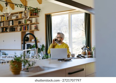 Man working from home while on phone call.