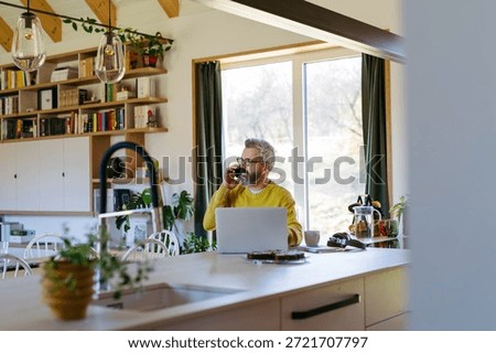 Man working from home while on phone call.