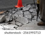 Man working with jackhammer on the road detail