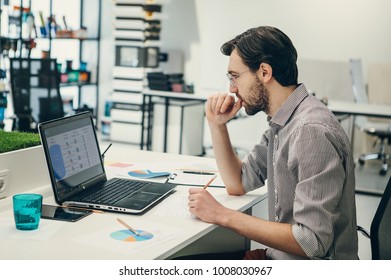 Man working with laptop in design studio