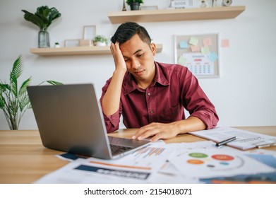 Man Working With Laptop And Paperwork With Stress