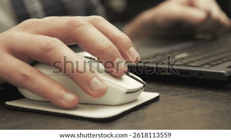 Man working with laptop while clicking mouse. Online working, technology concept