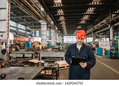 Man Working In Large Metal Industry Workshop.