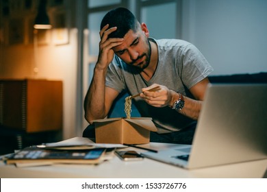 Man Working Late On Laptop Eating Chinese Food At His Home