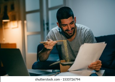 Man Working Late On Laptop Eating Chinese Food At His Home