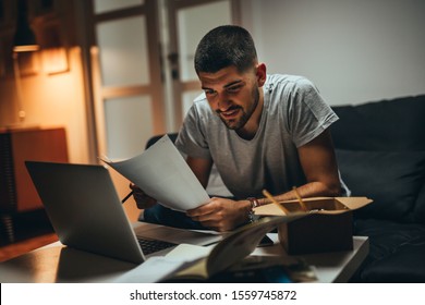 Man Working Late On Laptop Eating Chinese Food At His Home