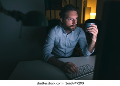 Man Working Long Hours On Computer. Bearded Man Working From His Home Office