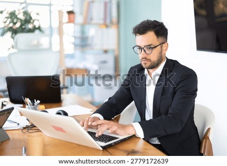 Man working in office, manager using laptop in work. Regional representative office company, carsharing, hiring staff.