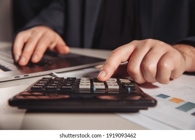 Man working in office using calculator. Business concept. Close-up