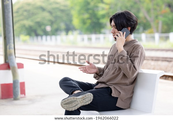 Man working om mobile call near railway station local
Thailand 