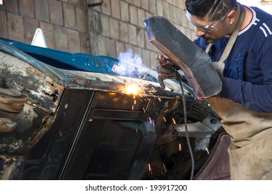 Man Working On Car Body