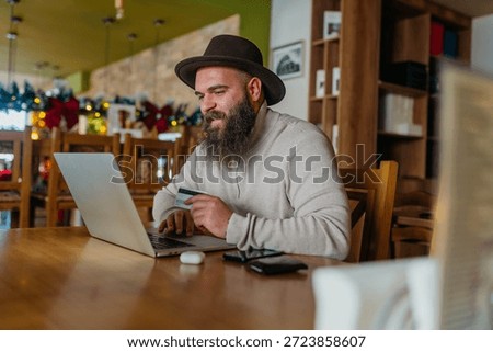 Man working on a computer in the caffe