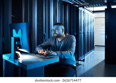 Man Working on Computer in Data Center