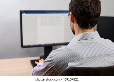 man working on computer in office, writing text - stock photo