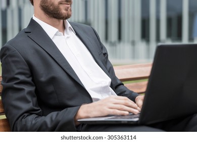 Man Is Working On Computer Outside Of Company