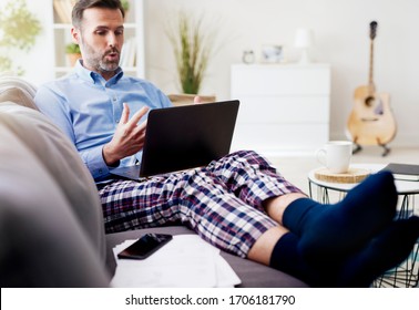 Man Working On Computer And Wearing Pajamas