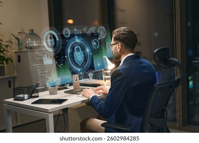 Man Working On Cybersecurity Analytics In Modern Office With Futuristic Holographic Visuals