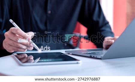 Man working on a digital tablet with a virtual advertising and digital marketing dashboard. This online business and media campaign concept shows a professional analyzing SEO optimization.