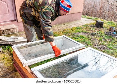 Man Working On Diy Project Construction Closeup Of Vegetable Winter Garden For Raised Bed Cold Frame Box In Ukraine Dacha By Farm House