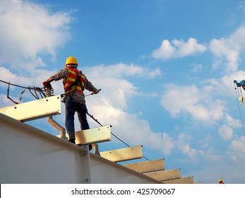 Man Working on the Working at height with blue sky