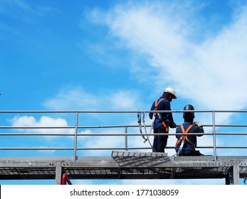 Man Working On The Working At Height On Construction Site With Blue Sky