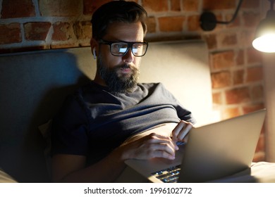 Man Working On His Laptop In The Bed At Night