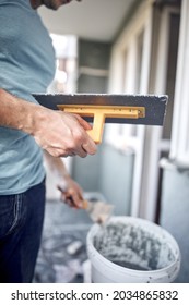 Man Working On A House Facade.