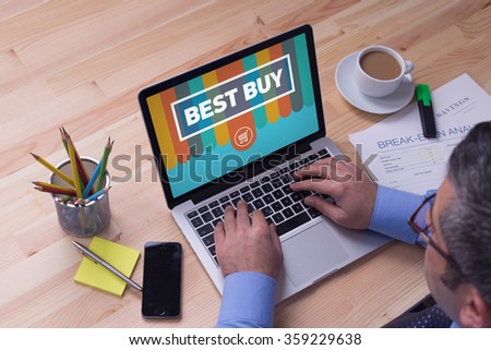 Man working on laptop with BEST BUY on a screen