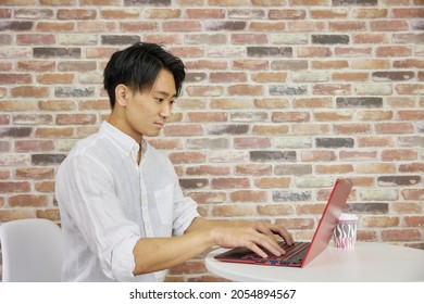 A man working on a laptop in a cafe space