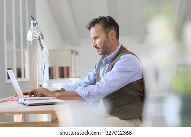 Man Working On Laptop Computer