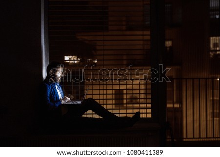 Similar – dark house at night with illuminated windows