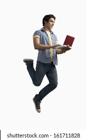 Man Working On A Laptop And Jumping