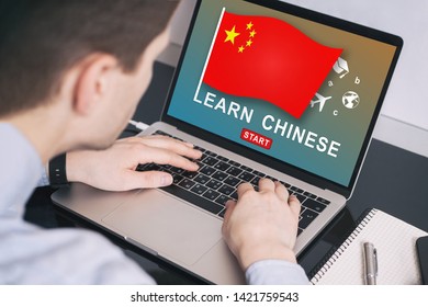 Man working on laptop with LEARN CHINESE on a screen. Education learning Chinese language school concept