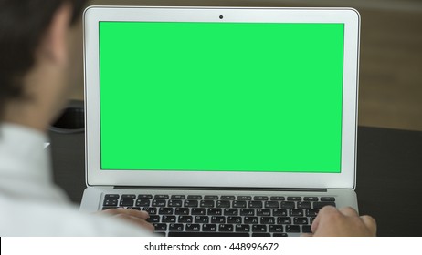 Man Working On Laptop In The Office. Green Screen.