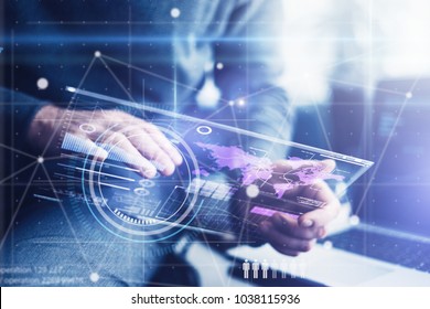Man working on a project using futuristic digital tablet