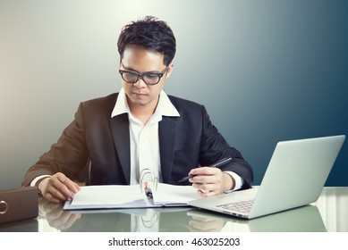 Man working on table wiht Laptop