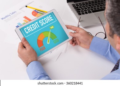 Man working on tablet with CREDIT SCORE on a screen - Shutterstock ID 360218441