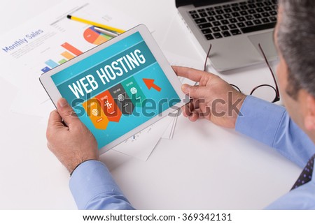Man working on tablet with WEB HOSTING on a screen