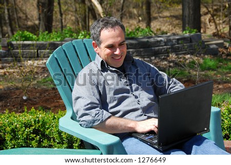 Man working on a thinkpad outside