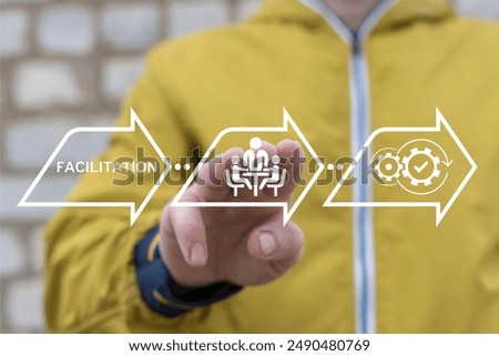 Man working on virtual interface sees word: FACILITATION. Concept of facilitation service. Business finance facilitating.